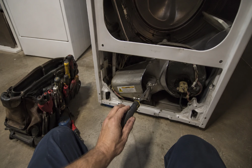 Dryer repair technician working on a residential dryer in Pace, FL